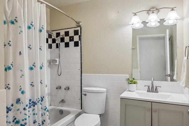 242 Koili Ln, Kapaa, HI 96746 - bathroom with toilet, vanity, shower / bath combo with shower curtain, tile walls, and a wainscoted wall
