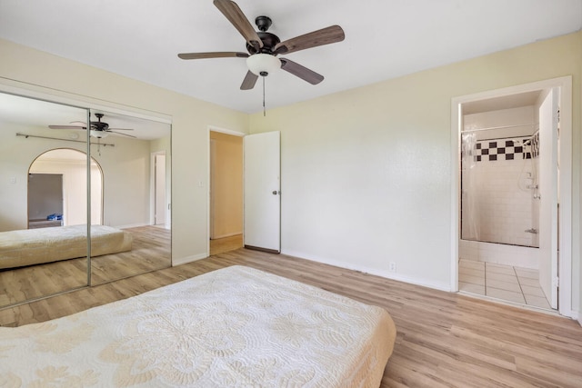 242 Koili Ln, Kapaa, HI 96746 - bedroom featuring wood finished floors, a closet, baseboards, and a ceiling fan