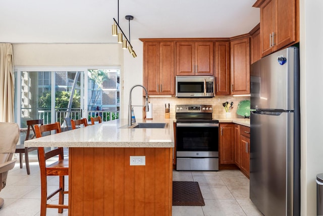 75-6016 Alii Dr Unit 126, Kailua-Kona, HI 96740 - kitchen with appliances with stainless steel finishes, a sink, a peninsula, tasteful backsplash, and brown cabinetry