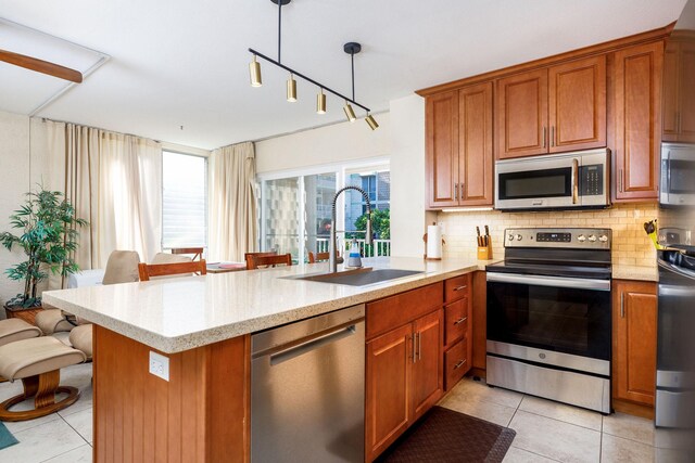 75-6016 Alii Dr Unit 126, Kailua-Kona, HI 96740 - kitchen featuring stainless steel appliances, a sink, a peninsula, and light tile patterned floors