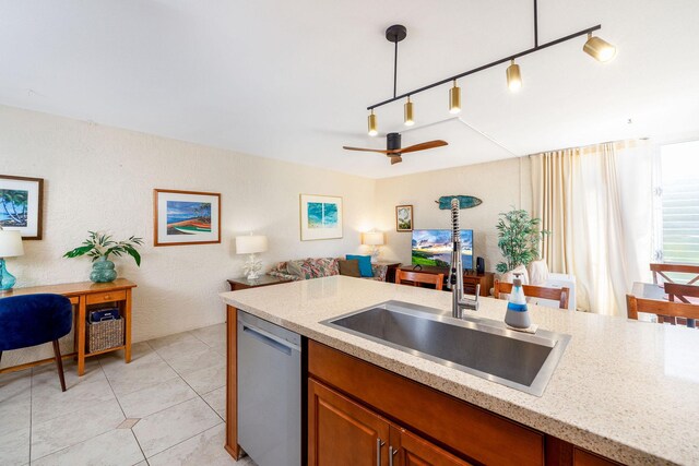 75-6016 Alii Dr Unit 126, Kailua-Kona, HI 96740 - kitchen featuring stainless steel dishwasher, a sink, open floor plan, light stone counters, and brown cabinets