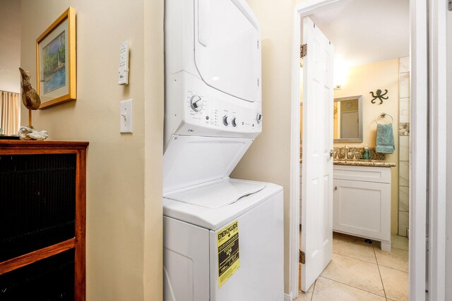 75-6016 Alii Dr Unit 126, Kailua-Kona, HI 96740 - laundry room with stacked washing machine and dryer and light tile patterned flooring