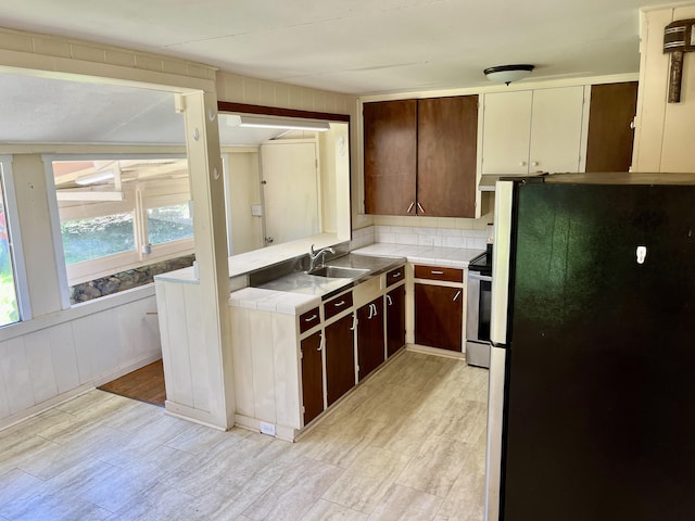 66-1750 Kawaihae Rd, Kamuela, HI 96743 - kitchen featuring freestanding refrigerator, tile counters, stainless steel electric range, and dark brown cabinets