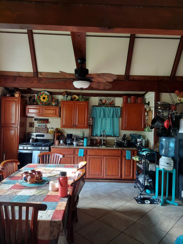 16-233 Orchid Land Dr, Keaau, HI 96749 - kitchen with stainless steel range with gas cooktop, a sink, brown cabinets, and light tile patterned flooring