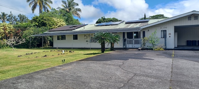 16-1397 35th Ave, Keaau, HI 96749 - single story home featuring a front lawn, roof mounted solar panels, asphalt driveway, and metal roof