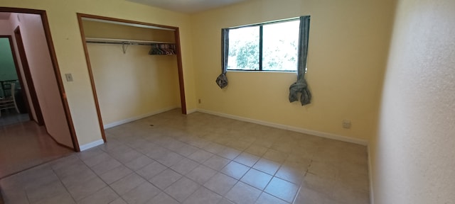 16-1397 35th Ave, Keaau, HI 96749 - unfurnished bedroom featuring a closet, tile patterned flooring, and baseboards
