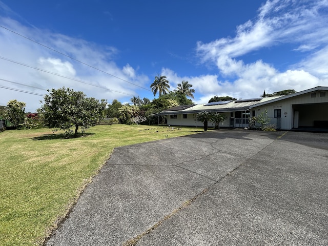 16-1397 35th Ave, Keaau, HI 96749 - view of front of home featuring solar panels, a front lawn, and driveway