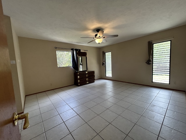 16-1397 35th Ave, Keaau, HI 96749 - empty room featuring plenty of natural light, light tile patterned flooring, a ceiling fan, and a textured ceiling