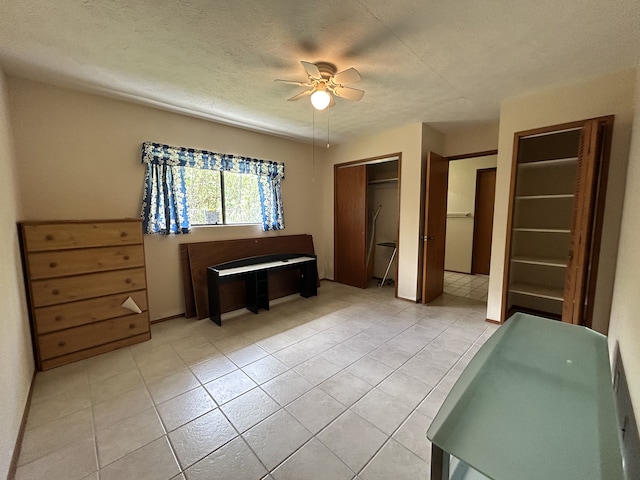 16-1397 35th Ave, Keaau, HI 96749 - bedroom with light tile patterned floors, a textured ceiling, and a ceiling fan