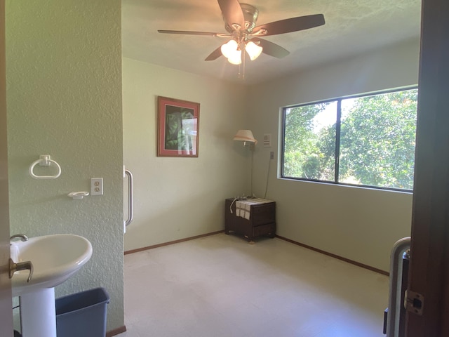 16-1397 35th Ave, Keaau, HI 96749 - bathroom with ceiling fan, a textured wall, tile patterned floors, a sink, and baseboards