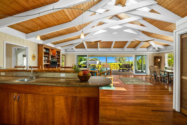 7205 Alealea Rd, Hanalei, HI 96722 - kitchen with a sink, wood finished floors, decorative light fixtures, brown cabinets, and open floor plan