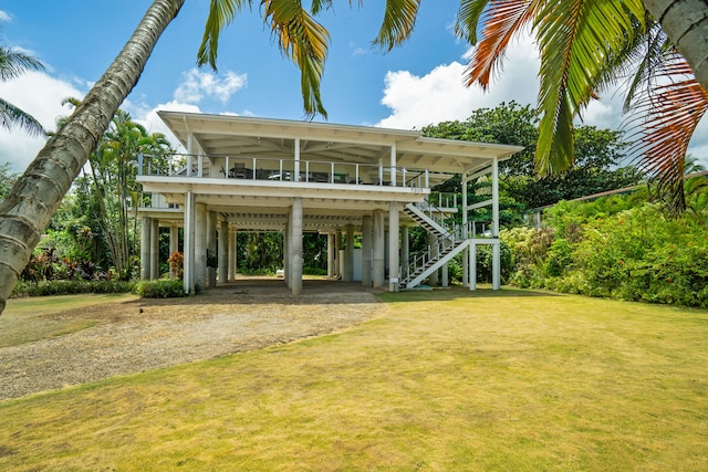 7205 Alealea Rd, Hanalei, HI 96722 - back of house featuring a carport, driveway, a lawn, and stairs