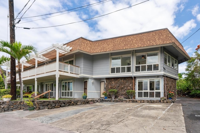 75-6150 Alii Dr Unit 7, Kailua-Kona, HI 96740 - view of front of home with roof with shingles, stone siding, and mansard roof
