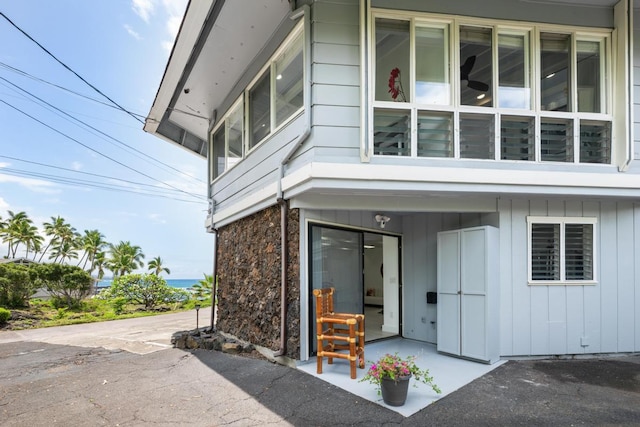75-6150 Alii Dr Unit 7, Kailua-Kona, HI 96740 - view of side of home with a patio area and board and batten siding