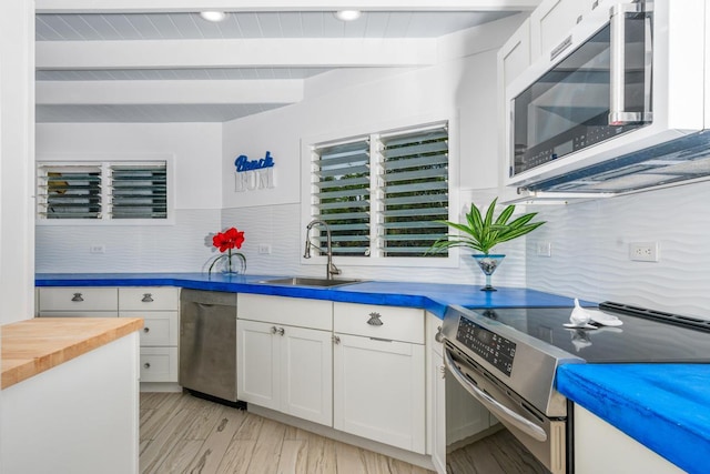 75-6150 Alii Dr Unit 7, Kailua-Kona, HI 96740 - kitchen with stainless steel appliances, butcher block counters, white cabinets, decorative backsplash, and beam ceiling