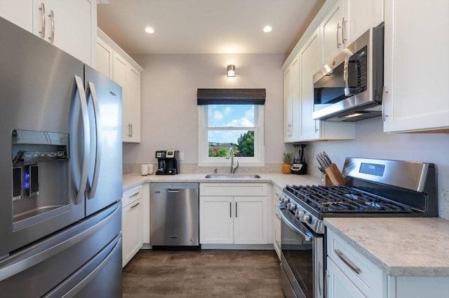 2650 Halalu St, Koloa, HI 96756 - kitchen featuring appliances with stainless steel finishes, a sink, white cabinetry, dark wood-style floors, and light countertops