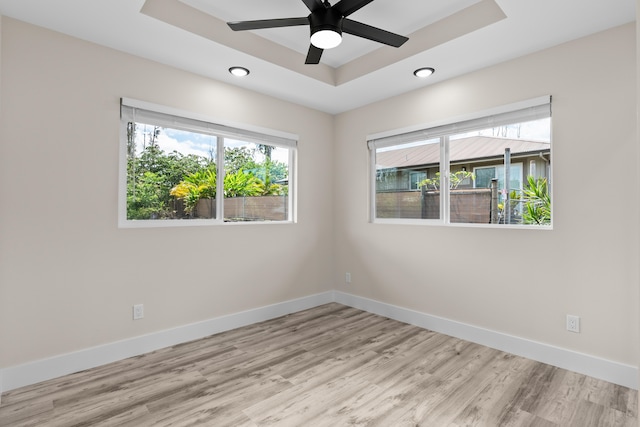 16-2168 Tree Fern Dr, Pahoa, HI 96778 - empty room featuring a tray ceiling, baseboards, light wood finished floors, and recessed lighting