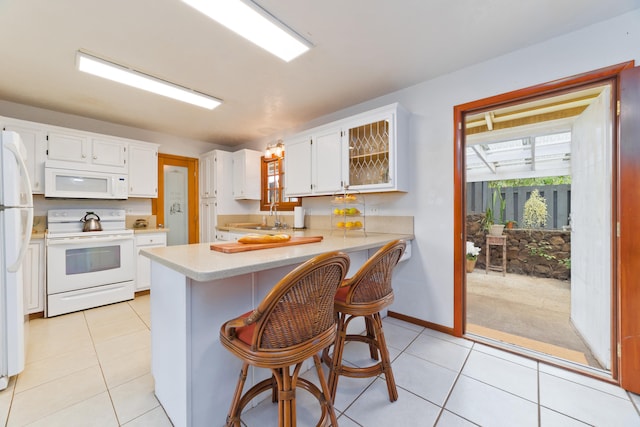 68-1884 Eha Ko Pl, Waikoloa, HI 96738 - kitchen featuring white appliances, a peninsula, a sink, light countertops, and light tile patterned flooring