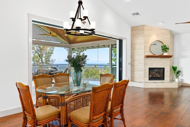 73-4566 Kukuki St, Kailua-Kona, HI 96740 - dining room featuring a chandelier, high vaulted ceiling, a premium fireplace, and wood finished floors