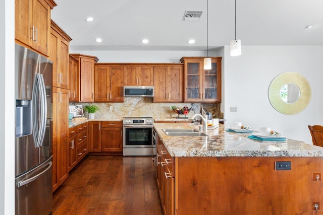 73-4566 Kukuki St, Kailua-Kona, HI 96740 - kitchen featuring appliances with stainless steel finishes, brown cabinets, dark wood-type flooring, and recessed lighting