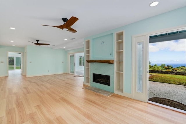 73-4566 Kukuki St, Kailua-Kona, HI 96740 - unfurnished living room with recessed lighting, a fireplace, a ceiling fan, light wood finished floors, and built in features