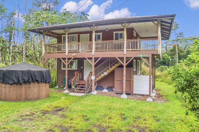 14-3535 Kahoolawe Rd, Pahoa, HI 96778 - rear view of property featuring a deck, stairway, a yard, and stucco siding