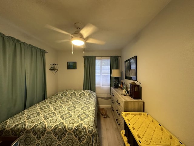 14-682 Kehau Rd, Pahoa, HI 96778 - bedroom featuring wood finished floors, a ceiling fan, and baseboards