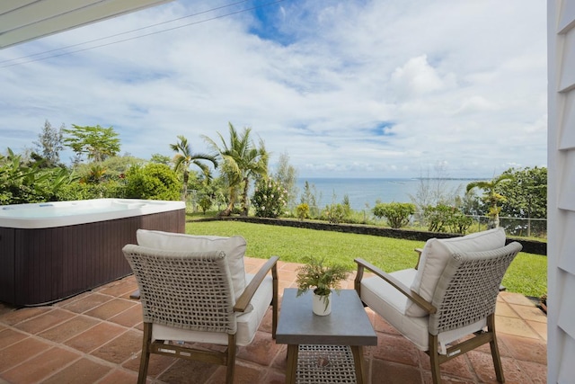 724-B Wainaku St, Hilo, HI 96720 - view of patio / terrace with a hot tub and a water view