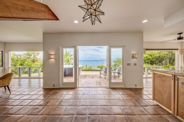 724-B Wainaku St, Hilo, HI 96720 - entryway featuring a water view, recessed lighting, baseboards, and a chandelier