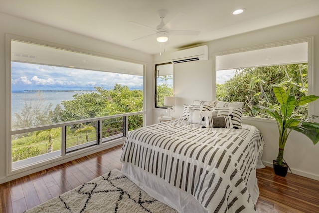 724-B Wainaku St, Hilo, HI 96720 - bedroom with a wall mounted air conditioner, hardwood / wood-style floors, a water view, a ceiling fan, and recessed lighting