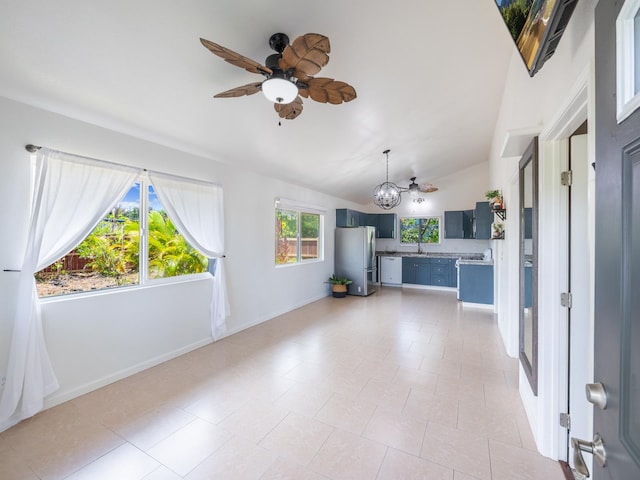 12-7038 Kehauopuna St, Pahoa, HI 96778 - unfurnished living room featuring vaulted ceiling, a chandelier, ceiling fan, baseboards, and a sink