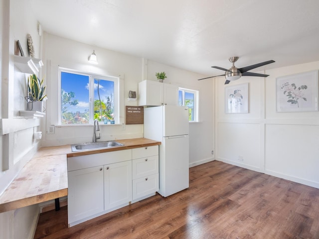 12-7038 Kehauopuna St, Pahoa, HI 96778 - kitchen featuring a sink, freestanding refrigerator, white cabinets, wood finished floors, and wood counters