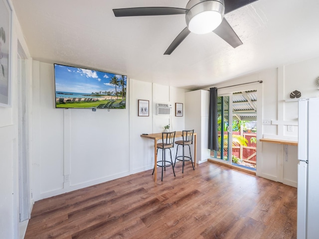 12-7038 Kehauopuna St, Pahoa, HI 96778 - dining area with wood finished floors, ceiling fan, and a wall unit AC