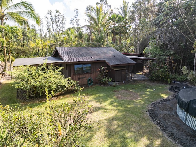 15-1625 11th Ave, Keaau, HI 96749 - back of property with a lawn, metal roof, and board and batten siding