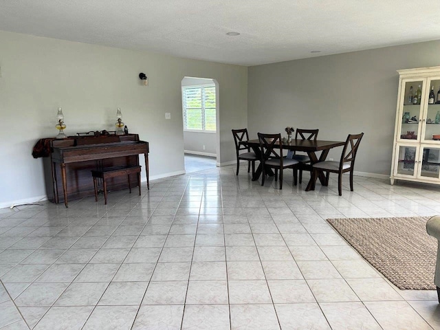 15-2694 Mano St, Pahoa, HI 96778 - dining room with arched walkways, light tile patterned floors, baseboards, and a textured ceiling