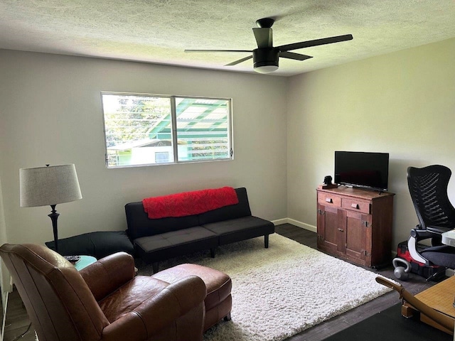 15-2694 Mano St, Pahoa, HI 96778 - living room with a ceiling fan, dark wood-style floors, baseboards, and a textured ceiling
