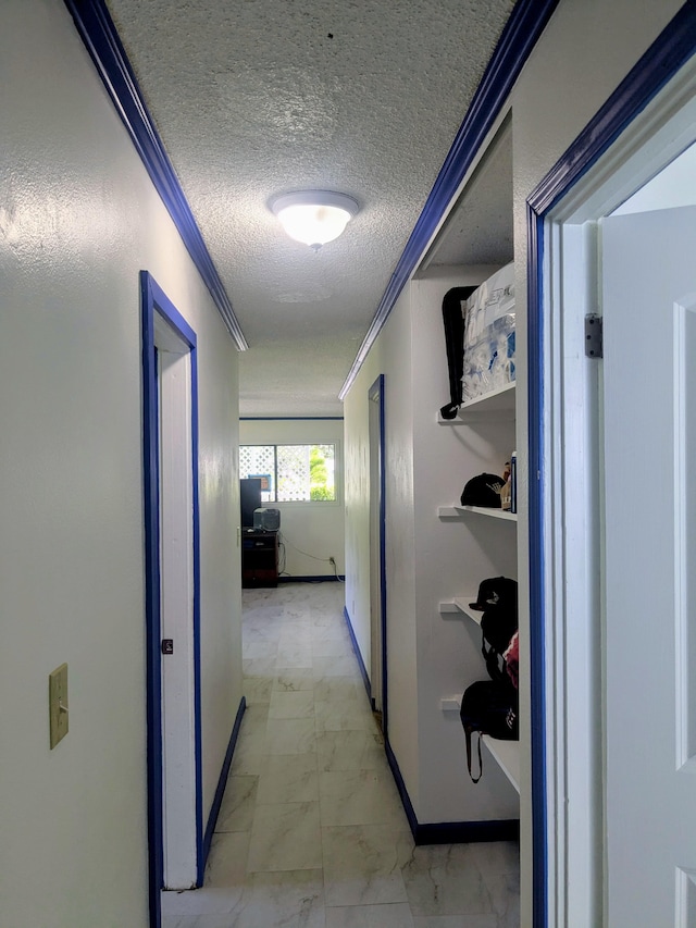 15-2714 Nenue St, Pahoa, HI 96778 - corridor featuring light marble finish flooring, a textured ceiling, crown molding, and baseboards
