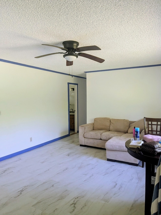 15-2714 Nenue St, Pahoa, HI 96778 - living room with ceiling fan, a textured ceiling, light marble finish floors, and baseboards