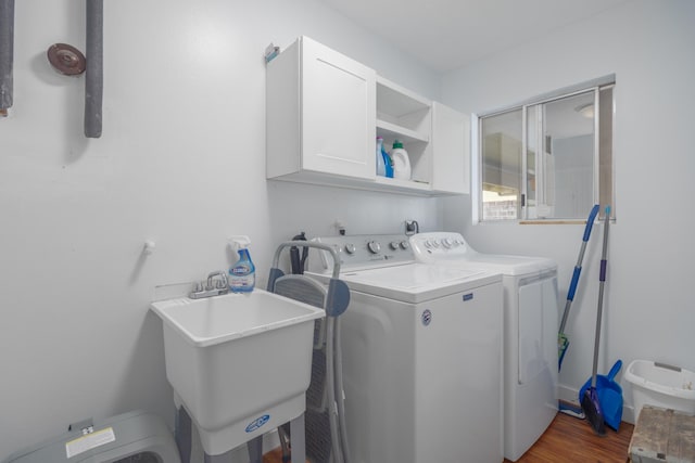 45-550 Miulana Pl, Honokaa, HI 96727 - washroom featuring cabinet space, washing machine and clothes dryer, and wood finished floors