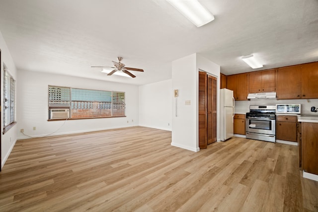 522 Aewa St, Eleele, HI 96705 - kitchen featuring appliances with stainless steel finishes, under cabinet range hood, brown cabinetry, light wood-style floors, and light countertops