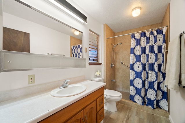 522 Aewa St, Eleele, HI 96705 - full bath with vanity, tiled shower, wood finished floors, and a textured ceiling