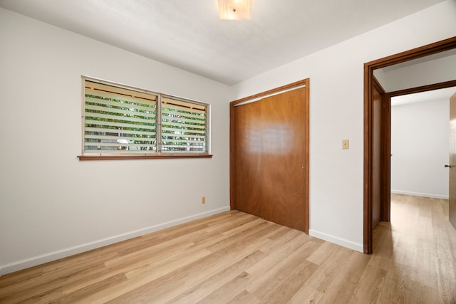 522 Aewa St, Eleele, HI 96705 - unfurnished bedroom with wood finished floors and a closet