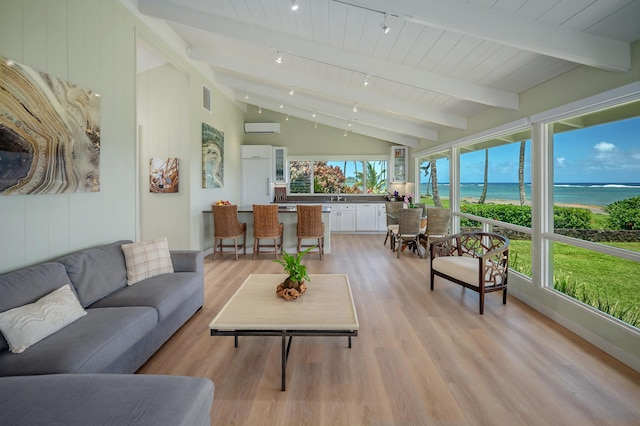 4059 Anini Rd, Kilauea, HI 96754 - sunroom with wood finished floors, a wall mounted AC, a water view, wooden ceiling, and rail lighting