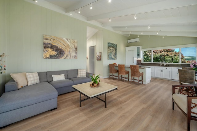 4059 Anini Rd, Kilauea, HI 96754 - living area with a wall unit AC, light wood finished floors, track lighting, and wooden walls