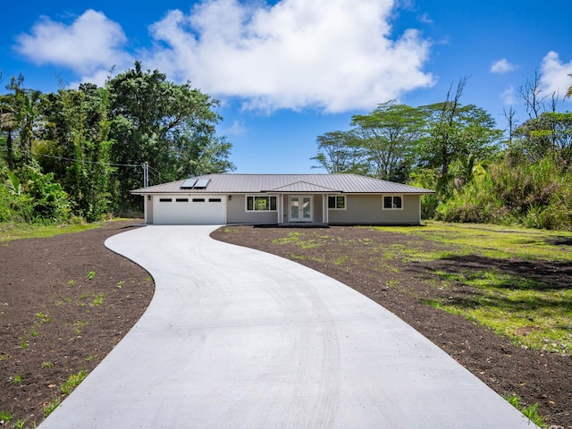 15-2047 9th Ave, Keaau, HI 96749 - single story home with french doors, an attached garage, driveway, solar panels, and metal roof
