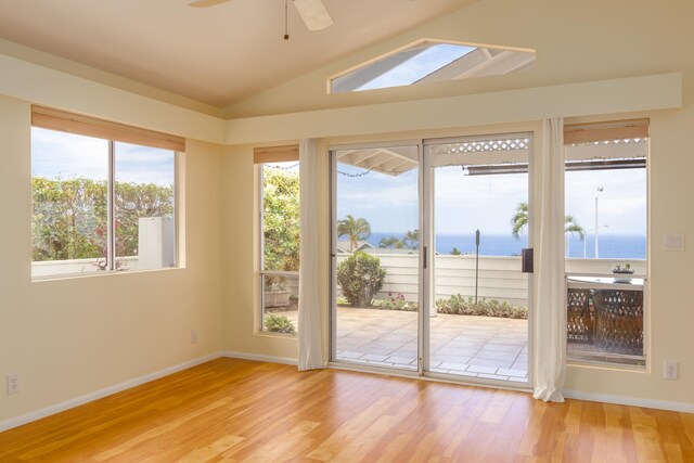 75-252 Nani Kailua Dr Unit 23, Kailua-Kona, HI 96740 - unfurnished room with wood finished floors, vaulted ceiling, baseboards, a ceiling fan, and a water view
