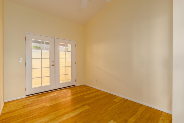 75-252 Nani Kailua Dr Unit 23, Kailua-Kona, HI 96740 - unfurnished room with french doors, light wood-type flooring, baseboards, a ceiling fan, and vaulted ceiling