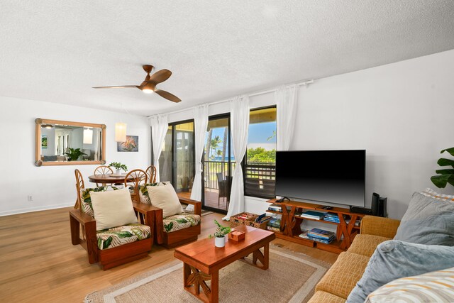4330 Kauai Beach Dr Unit E5, Lihue, HI 96766 - living room with a textured ceiling, light wood-style floors, and ceiling fan