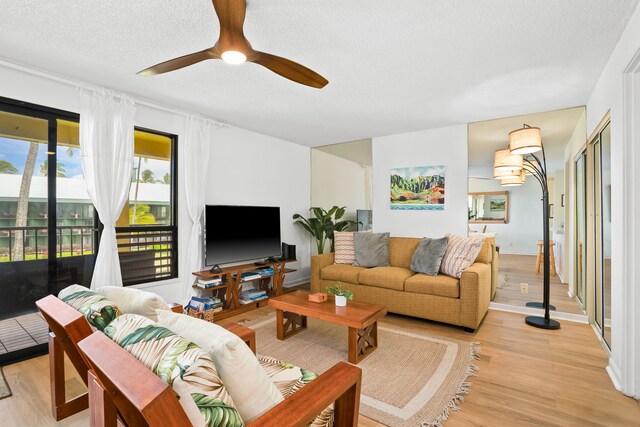 4330 Kauai Beach Dr Unit E5, Lihue, HI 96766 - living room featuring a textured ceiling, light wood finished floors, and a ceiling fan