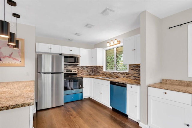 14-882 Kehau Rd, Pahoa, HI 96778 - kitchen with stainless steel appliances, a sink, dark wood-style flooring, decorative backsplash, and white cabinets